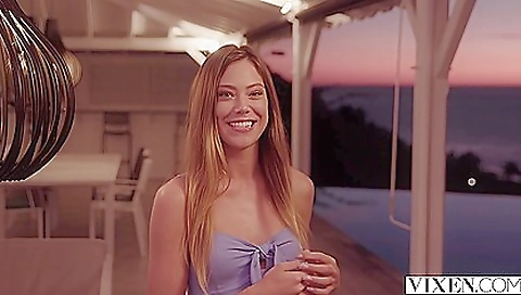 Hot blonde babe is on the beach getting her feet soaked