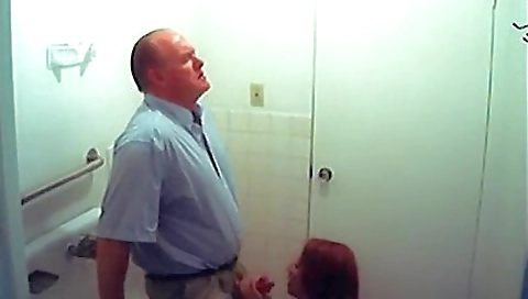 Busty redhead in the bathroom with small tits sucking her dick