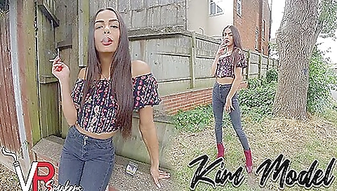 Horny brunette is smoking a cigarette and blowing air