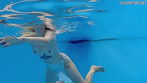 Stunning babe shows off the best on a hot pool beach